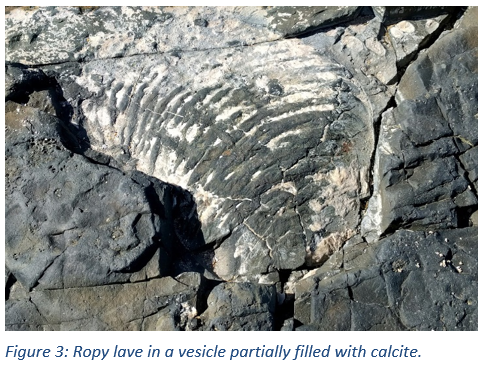 Figure 3: Ropy lave in a vesicle partially filled with calcite.